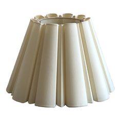 a lamp shade that is white and has four lampshades on top of it