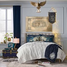 a bedroom decorated in blue and white with gold accents