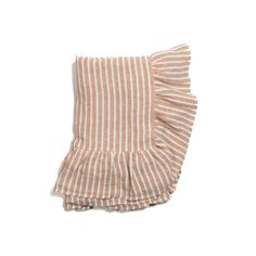 an orange and white striped pillow with ruffles on the bottom, against a white background