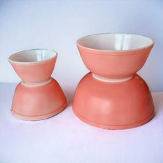 two pink bowls sitting on top of each other