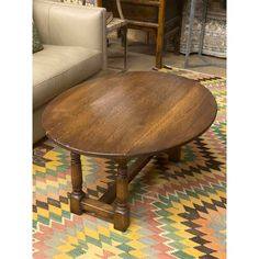 a wooden table sitting on top of a colorful rug