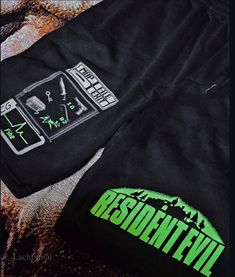 a pair of black sweatpants with neon green print on them