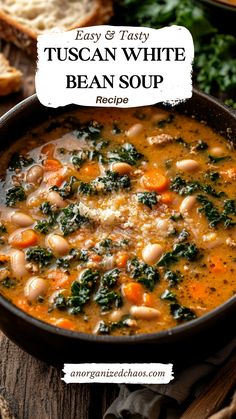 a bowl of bean soup with spinach, carrots and bread on the side