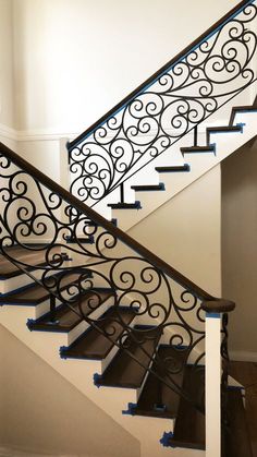 an iron stair railing with blue tape on it