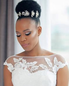 a woman wearing a wedding dress with flowers in her hair