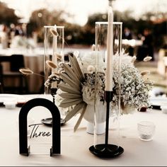 the centerpieces are arranged on top of each other, including flowers and candles