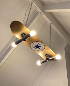 a skateboard suspended from the ceiling with lights