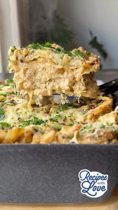 a casserole dish with broccoli and cheese being lifted from the casserole