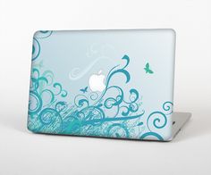 an apple laptop with blue swirls and butterflies on it