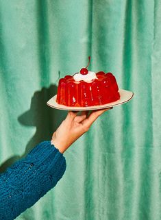 a person holding a plate with a cake on it