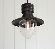 a light hanging from a ceiling fixture with a clear glass dome on the top and bottom