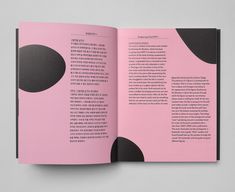 an open pink book with black circles on the cover and inside pages that are in chinese