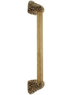 an ornately designed brass door handle on a white background