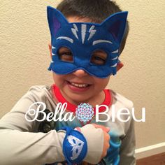 a young boy wearing a blue cat mask