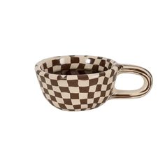 a brown and white checkerboard coffee cup on a white background with the handle extended