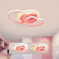 the ceiling lights in this room are shaped like heart - shaped clouds and pink walls