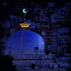 a large blue dome with a green moon in the background