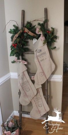 an old ladder decorated for christmas with stockings hanging from it