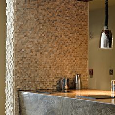 a bathroom with a sink, mirror and tiled wall