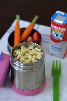 a lunch box with macaroni, carrots and milk