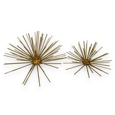 two brass sunbursts on white background