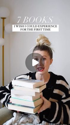 a woman holding a stack of books with the caption 7 books which could experience for the first time