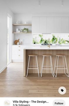 an image of a kitchen setting with bar stools in front of the counter top