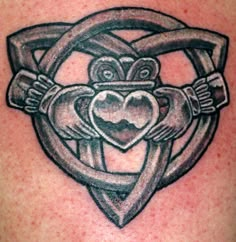 an image of a tattoo on the back of a man's shoulder with two hands holding