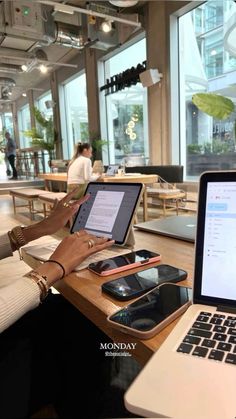 a person sitting at a table with a laptop