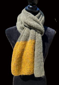 a yellow and grey scarf on top of a mannequin