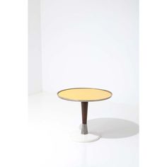 a small round table with wooden legs and an oval top, on a white background