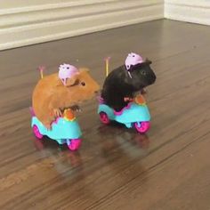 two small toy mice riding on top of each other