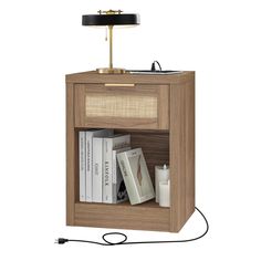 a nightstand with a lamp and books on it