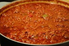 a large pot filled with chili on top of a stove