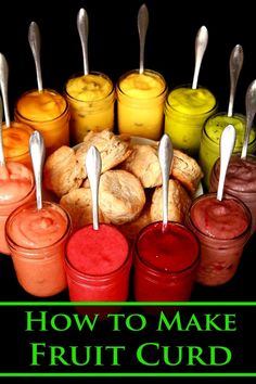 several jars filled with different types of fruit juices and spoons in front of them