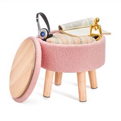 a pink stool with a pair of scissors on it