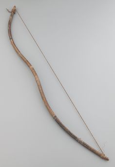 an old bow and arrow are on display