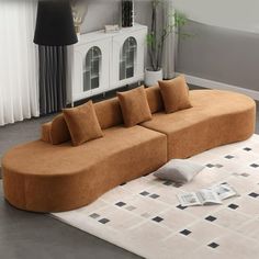 a large couch sitting on top of a white rug