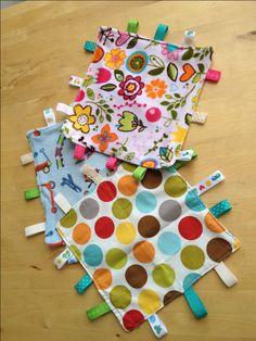 three baby bibs are laid out on a table