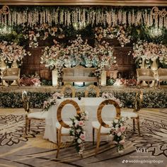 an elegant wedding setup with flowers and chairs