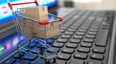 a shopping cart sitting on top of a laptop keyboard