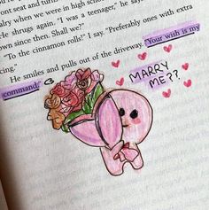 an open book with a drawing of a pink elephant and flowers on it's cover