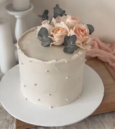 there is a white cake with flowers on it