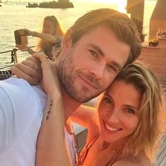 a man and woman posing for a photo on a boat