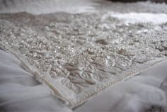 closeup of white wedding dress with beads on it