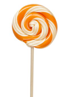 an orange and white striped lollipop on a stick