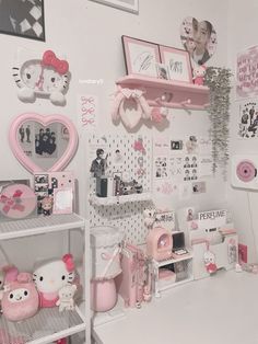 a room with hello kitty decorations and pictures on the wall, including teddy bear figurines