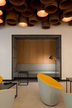 an office with modern furniture and lighting in the ceiling, as well as round lights