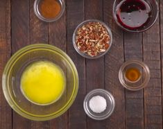 the ingredients are in bowls on the wooden table