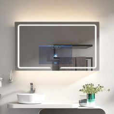 a bathroom sink with a mirror above it and a vase on the counter next to it